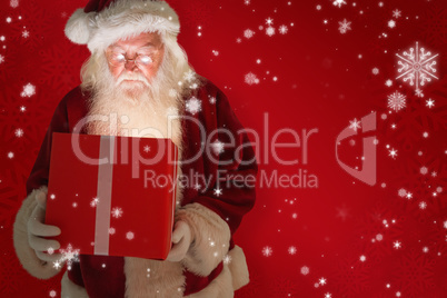 Composite image of father christmas opening a magical christmas