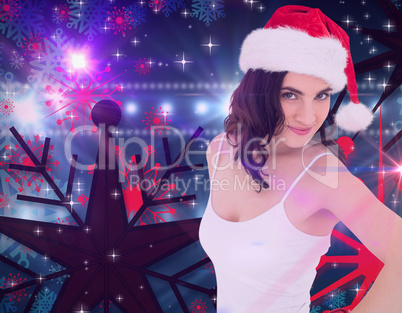 Composite image of portrait of a pretty brunette in santa hat