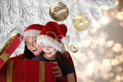 Composite image of mother and daughter opening gift