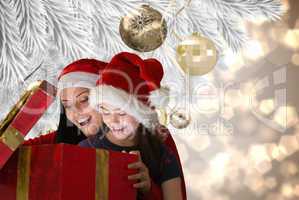 Composite image of mother and daughter opening gift