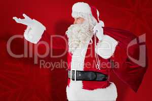 Composite image of santa with hand out and holding sack