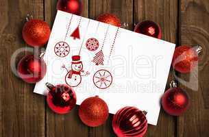 Composite image of hanging red christmas decorations