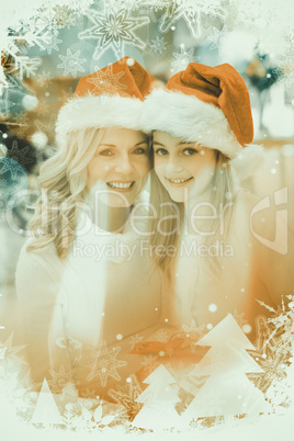 Composite image of festive mother and daughter smiling at camera