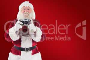 Composite image of santa is taking a picture