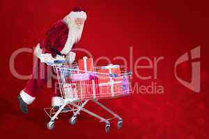 Composite image of santa rides on a shopping cart