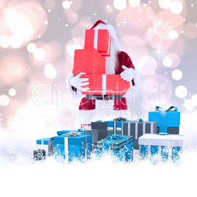 Composite image of santa covers his face with presents