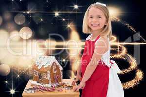 Composite image of festive little girl making gingerbread house