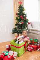 Composite image of cute boy and baby brother at christmas