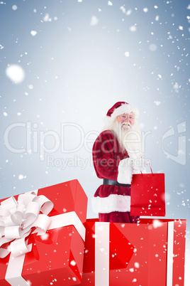 Santa standing in large gift