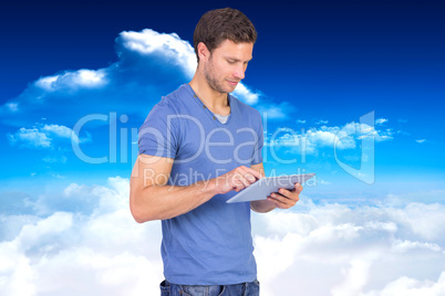 Composite image of man scrolling through tablet pc