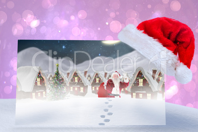 Composite image of santa delivery presents to village