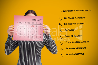 Composite image of businesswoman showing a calendar in front of