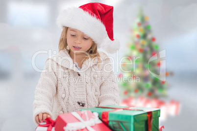 Composite image of cute little girl with gifts