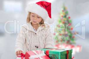 Composite image of cute little girl with gifts