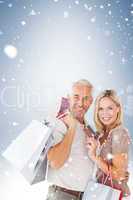 Happy couple with shopping bags and credit card