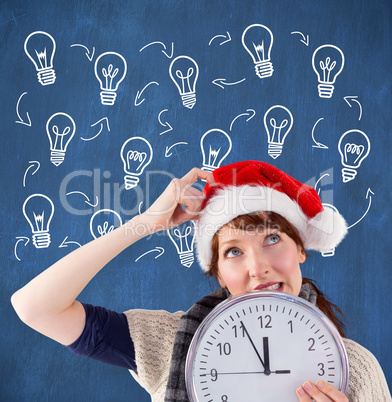 Composite image of woman holding a large clock