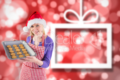 Composite image of festive blonde showing hot cookies