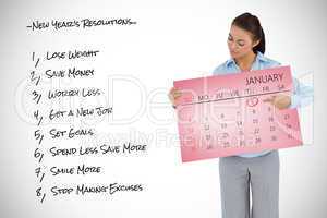 Composite image of young businesswoman looking at the calendar s