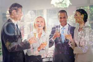 Composite image of business team celebrating with champagne