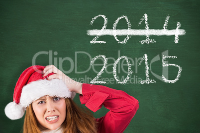 Composite image of festive stressed redhead holding gifts