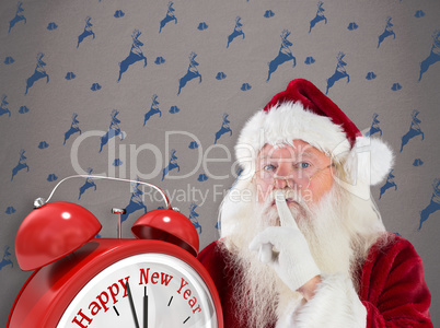 Composite image of santa asking for quiet to camera