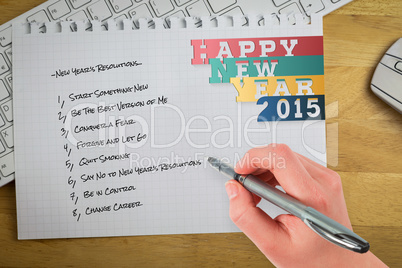 Composite image of businesswomans hand writing with pen
