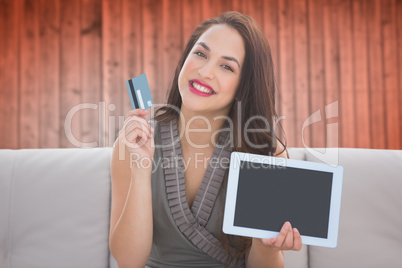 Composite image of smiling woman with tablet