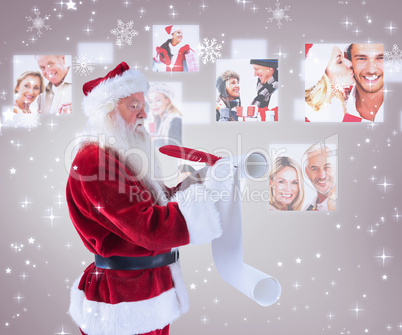 Composite image of father christmas writes a list