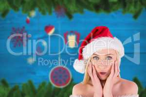 Composite image of festive blonde looking surprised with hands o