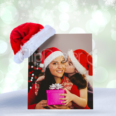 Composite image of daughter giving her mother a christmas presen