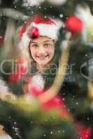 Composite image of festive litte girl decorating christmas tree
