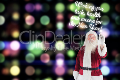 Composite image of santa writes something with a pen