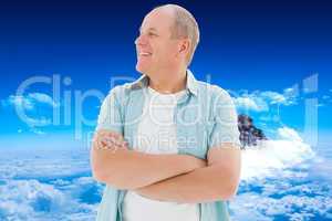 Composite image of happy older man with arms crossed