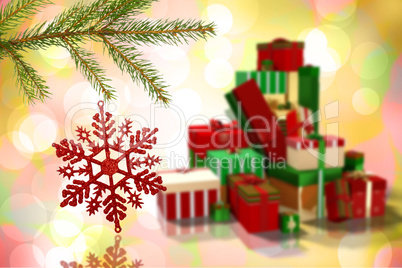 Composite image of red christmas decoration hanging from branch