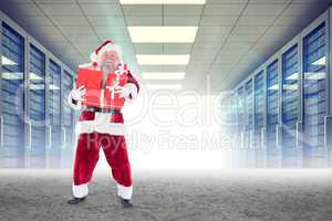 Composite image of santa carrying gifts
