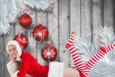 Composite image of festive blonde using tablet pc