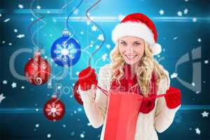 Composite image of happy festive blonde with shopping bag