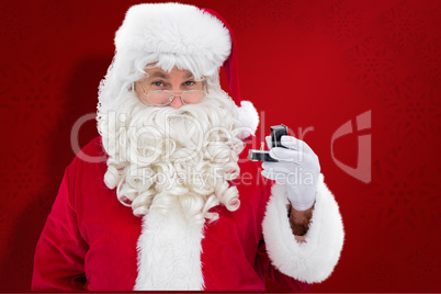 Composite image of cheerful santa holding a jewelry box