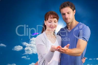 Composite image of couple holding out their hands