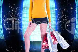 Composite image of stylish woman with shopping bags