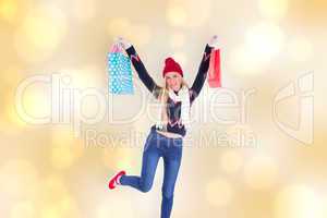 Composite image of festive blonde holding shopping bags