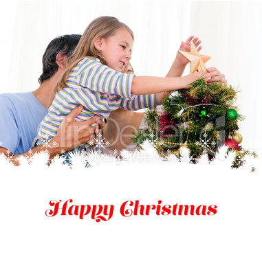 Composite image of little girl placing a star in a christmas tre