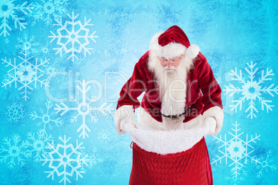 Composite image of santa looks in his bag