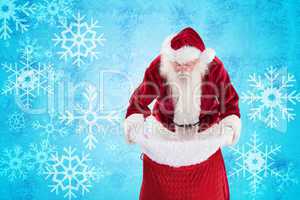 Composite image of santa looks in his bag