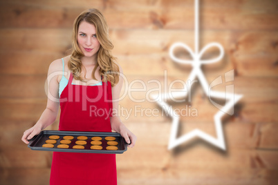 Composite image of pretty blonde showing hot cookies