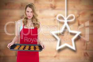 Composite image of pretty blonde showing hot cookies