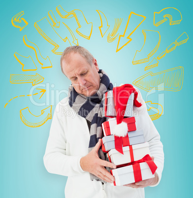 Composite image of festive man holding christmas gifts