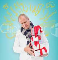 Composite image of festive man holding christmas gifts