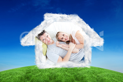 Composite image of caress young couple lying together on the sof