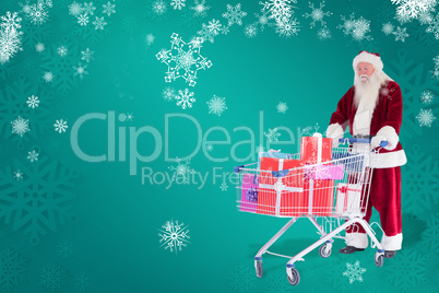 Composite image of santa pushes a shopping cart with presents